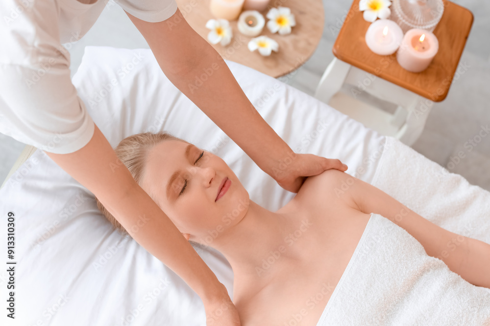 Poster young woman having relaxing massage in spa salon