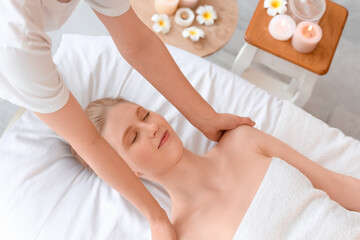 Young woman having relaxing massage in spa salon