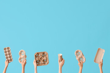 Female hands holding different litter on blue background. Recycling concept