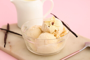 Bowl with scoop of vanilla ice cream on board on pink background