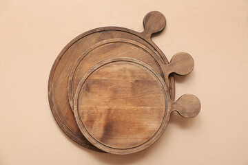 Wooden cutting boards on beige background
