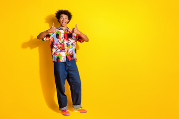 Full size photo of nice young man thumb up empty space wear shirt isolated on bright yellow color background