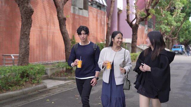 Taiwanese man and woman in their 20s and a South Asian woman walking together and chatting amicably on a university campus in Da&rsquo;an District, Taipei City, Taiwan.&nbsp;