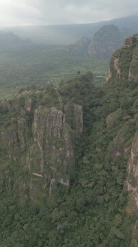 Vertical drone video. Rock formations, forested mountains and large formations. Hiking through the green forest. Hiking concept. Amatlan, Mexico