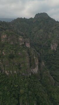 Vertical drone video. Rock formations, forested mountains and large formations. Hiking through the green forest. Hiking concept. Amatlan, Mexico