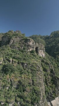 Vertical drone video. Rock formations, forested mountains and large formations. Hiking through the green forest. Hiking concept. Amatlan, Mexico