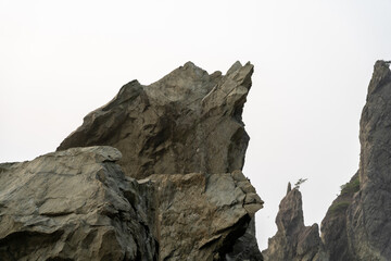 A beautiful view of giant rocks and ocean at Rialto Beach on a cloud day.