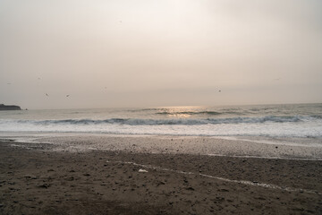 A beautiful view of giant rocks and ocean at Rialto Beach on a cloud day.