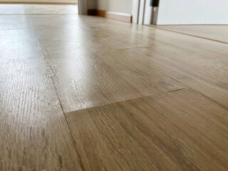 The laminate flooring in the room was damaged due to water penetrating the wood for too long.