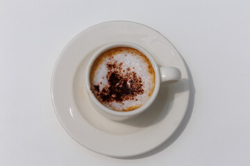 A cup of mocha coffee isolated on white background, top view. A cup of coffee in sunny day, summer vacation concept, close up