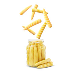 Baby corn cobs falling into jar on white background