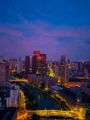 Obraz premium Aerial view of modern city skyline and burning clouds at sunrise in Shanghai.