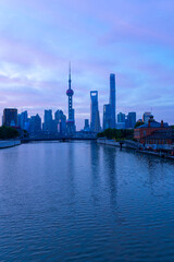 Naklejka premium view of modern city skyline and burning clouds at sunrise in Shanghai