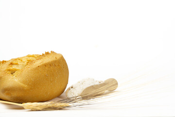 soft bread with flour, ears of wheat and a rolling pin isolated on a white background and copy space