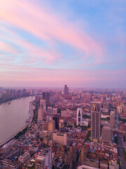 Fototapeta premium Aerial view of modern city skyline and burning clouds at sunrise in Shanghai.