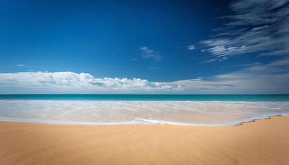 Fototapeta premium A coast with a wide sandy beach. A sandy beach with a blue sky.