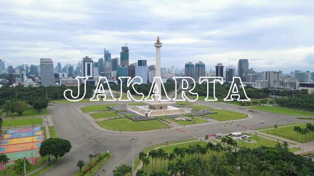 Landscape video with the text "Welcome to Jakarta" written in white on a beautiful aerial view of National Monument also known as Monas in Jakarta, Indonesia as video background