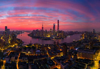 Aerial view of modern city skyline and burning clouds at sunrise in Shanghai