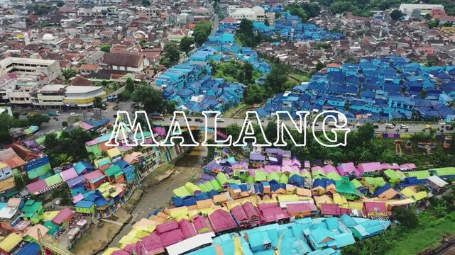 Landscape video with the text "Welcome to Malang" written in white on a beautiful aerial view of Colorful Rainbow Village in Malang, East Java, Indonesia as video background