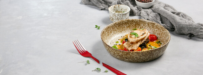 Grilled Squid with Cherry Tomatoes and Olives in Rustic Bowl on Light Background - Gourmet Seafood...