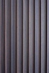 Wood battens wall straight line background texture. Architecture indoor and outdoor material in brown color.