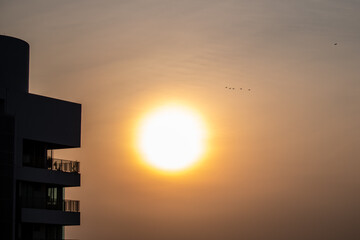 Six F15 fighter jets flying in front of a full sunset in Singapore in preparation of the 2024 Singapore National Day, Singapore's 59th Birthday.