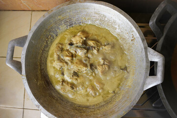top view of Opor Ayam (Indonesian chicken curry) in the making, a popular traditional indonesian dish