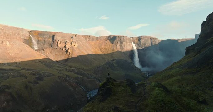 Adventurer Standing On Cliff Overlooking Haifoss Waterfall