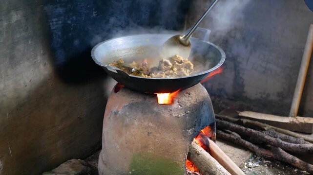 The process of cooking Rendang on a Earthenware furnace or tungku gerabah is Indonesian local stove made from clay, Rendang is a popular traditional indonesian dish