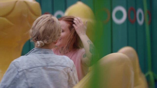 Women Having Fun On Duck-Shaped Ride At Fair