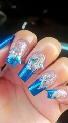 A person holding a blue and white manicure with a star on it