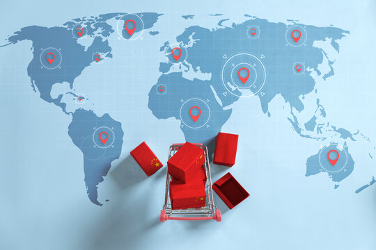 Packing and Shipping Boxes with the National flags of China on shopping carts with pin markings on the world map idea for expanding Chinese e-commerce's Rapid global growth.trade war. China economic
