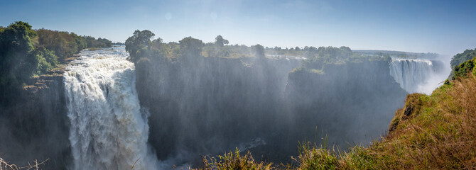 Victoria Falls, Mosi-oa-Tunya, is a waterfall on the Zambezi River, located on the border between Zambia and Zimbabwe. It is one of the world's largest waterfalls, with a width of 1,708 m