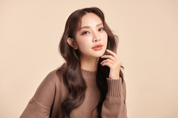Fototapeta premium Beautiful young asian woman with clean fresh skin on beige background, Face care, Facial treatment, Cosmetology, beauty and spa, Asian women portrait.