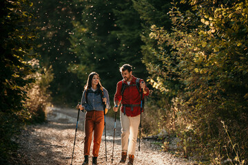 Two friends hikers in the forest, walking and seeking for a good place to camp