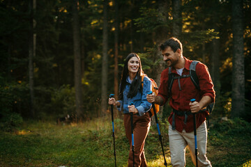 Shot of a happy young couple going for a romantic walk in the woods