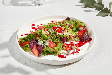 Fresh Strawberry and Blue Cheese Salad with Nuts on White Plate