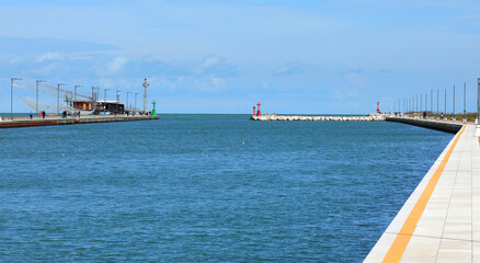 navigable canal leading to the port Without boats and the sea in the background