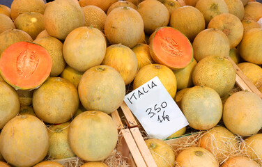 melons at a fruit vendor s stall with a price tag in Italy during the summer season
