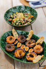 grilled peaches and vegetable salad on set summer table