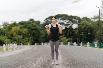 Attractive Asian woman running in the park Healthy lifestyle and jogging of sports concept girl