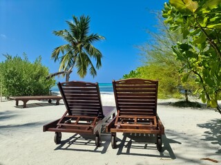 Beach loungers on the dream white beach of the Maldives.