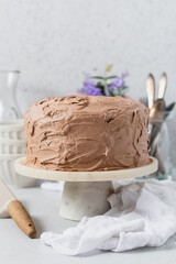 Birthday chocolate cake on white marble cakestand