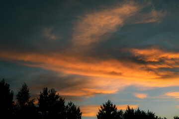 Orange cloud formations abstract nature background. Sky at sunset, orange cirrus clouds. Dramatic...