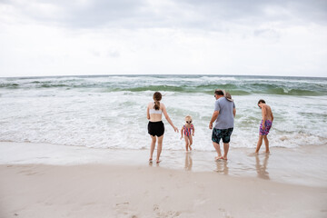 Family playing in shoreline at Gulf Shores