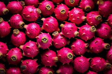 A pile of fresh dragon fruit form the background, shown from above