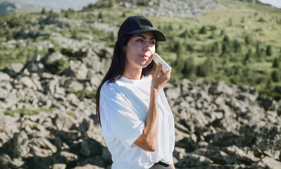 Woman applying sun cream in the summer mountain .Spf stick 