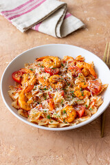 Farfalle pasta with shrimps, tomatoes and cheese. Healthy eating. Italian food.