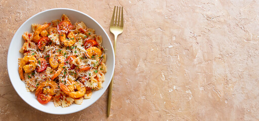 Farfalle pasta with shrimps, tomatoes and cheese. Healthy eating. Italian food.