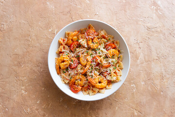 Farfalle pasta with shrimps, tomatoes and cheese. Healthy eating. Italian food.